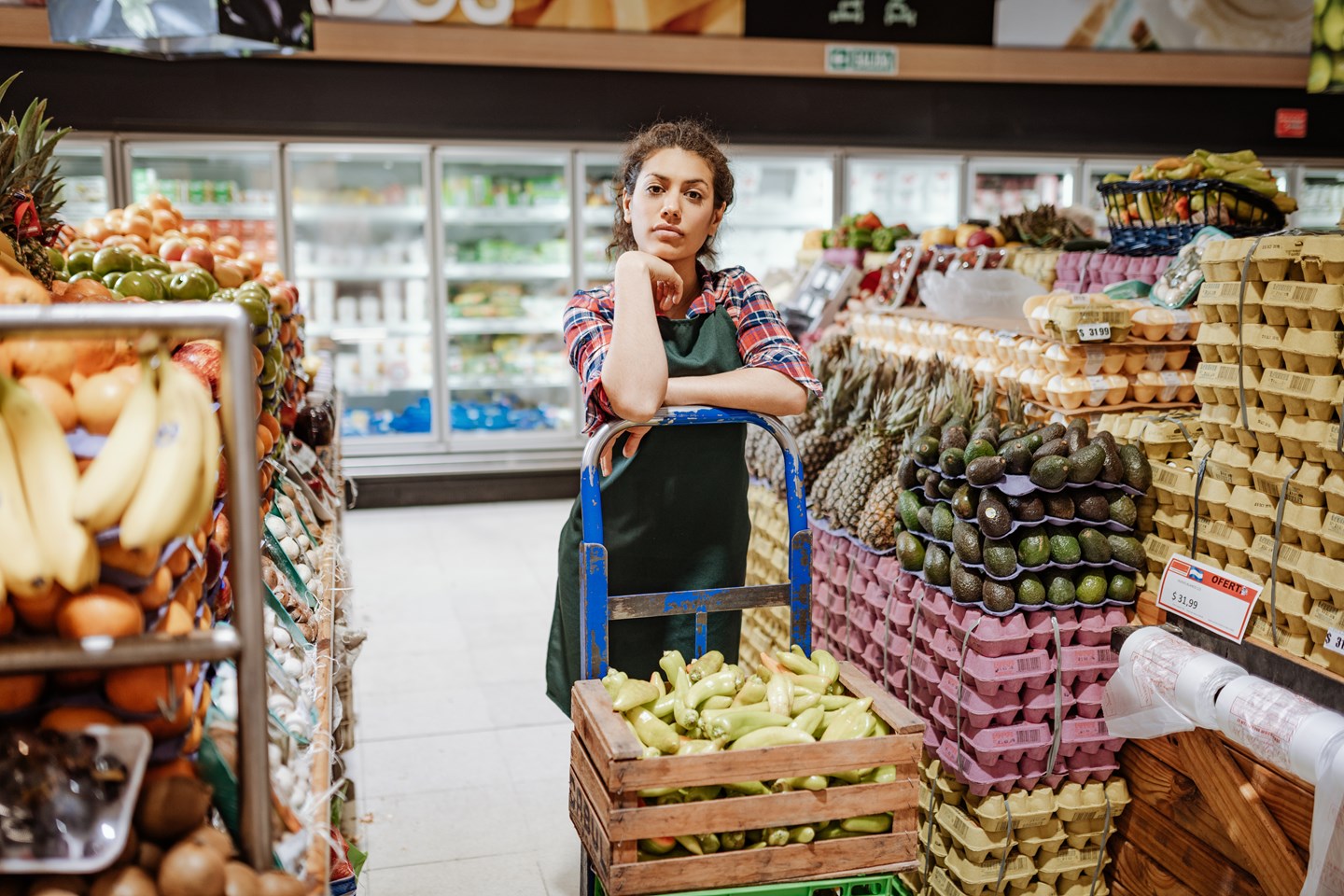 Woman standing at the produce section of the grocery store