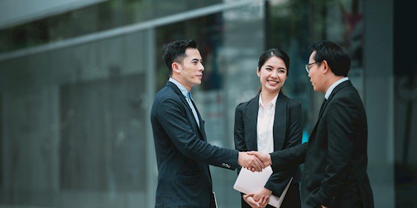 Professionals outside shaking hands