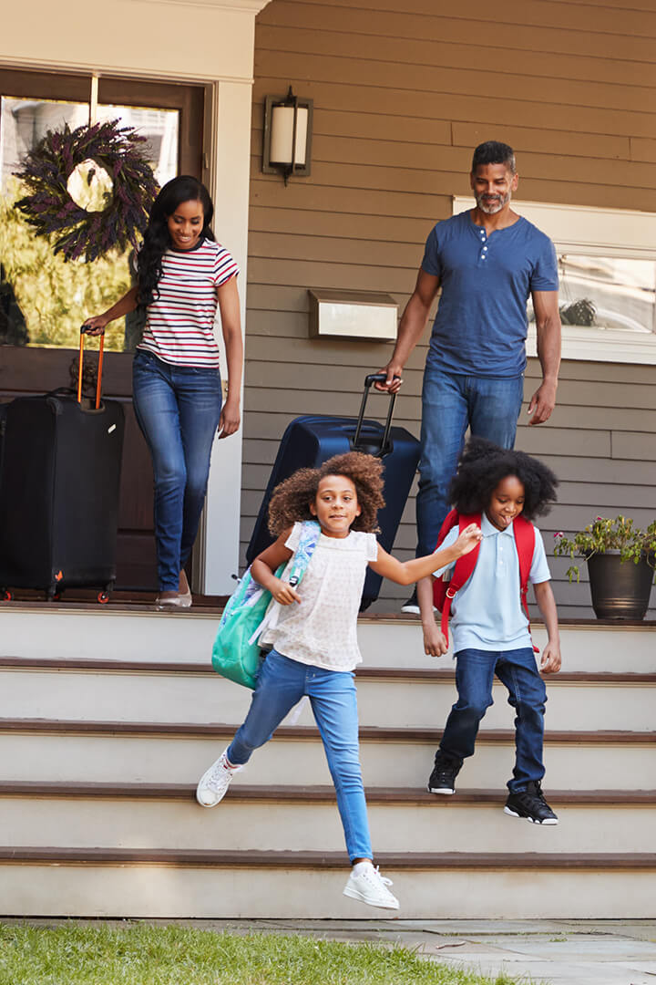 Family leaving the house to go on vacation