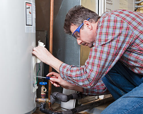 Man working on a water heater